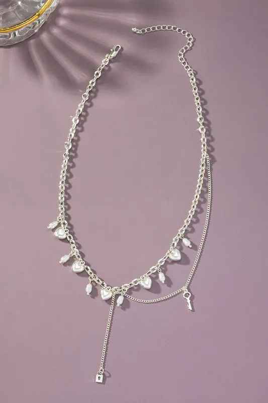 Asymmetric necklace with puffy heart drops