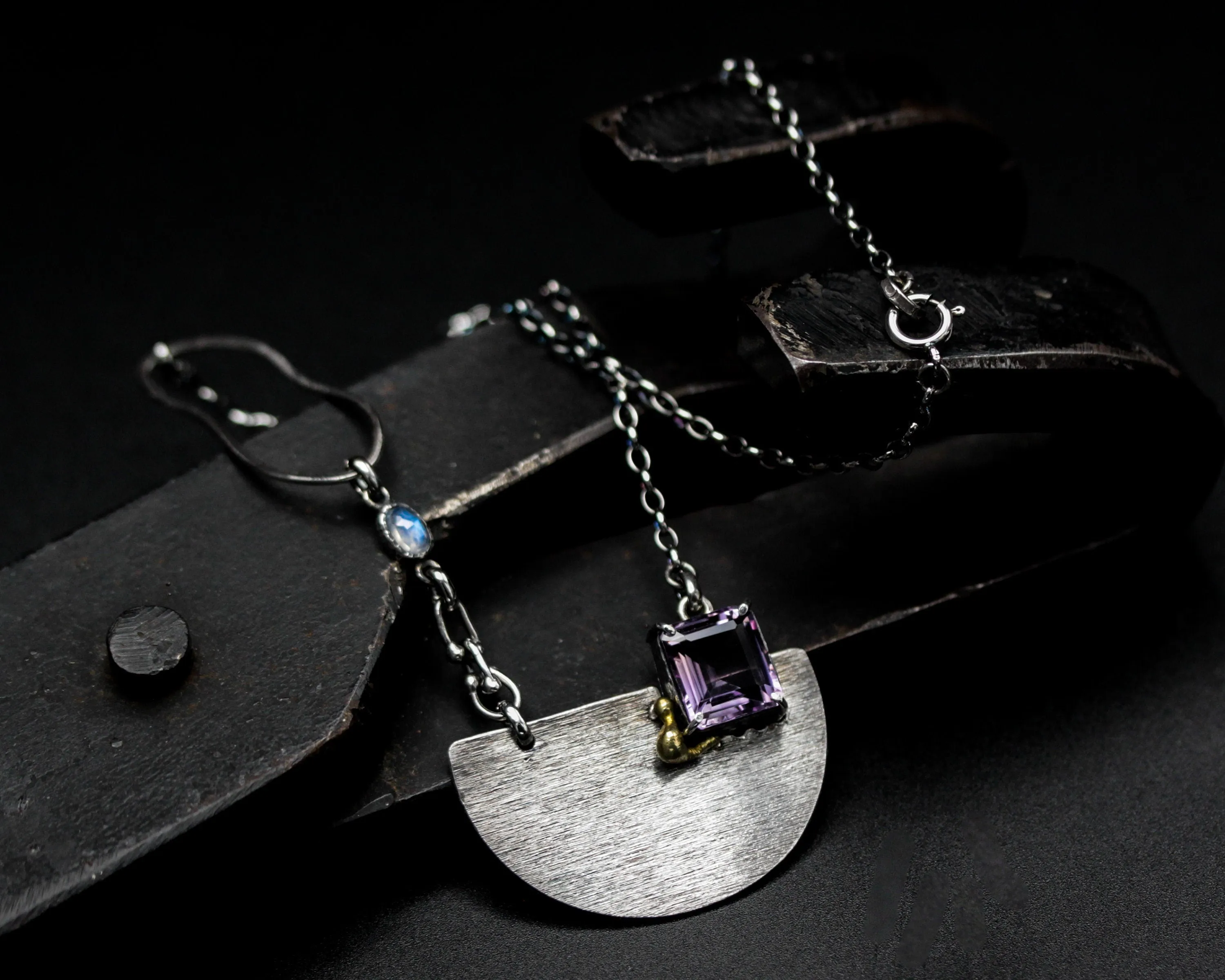 Princess cut amethyst pendant necklace in silver bezel and prongs setting with silver semi-circle shape on sterling silver chain