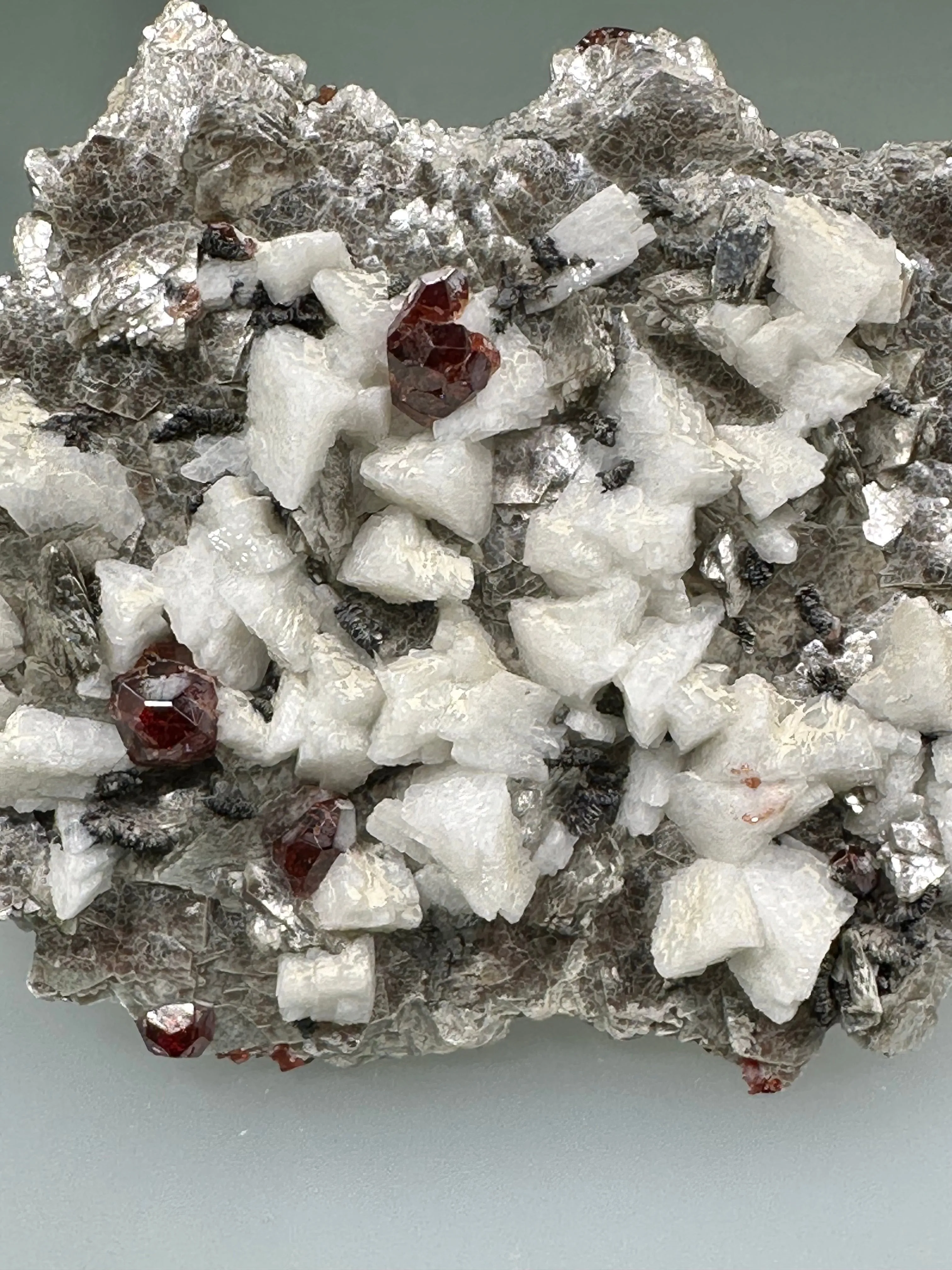 Spessertine and Albite on Muscovite, Tongbei, Fujian Province, China, Mined c. early 2000s, ex. WIlliam Mickols Collection WEM591, Small Cabinet, 1.3 x 6 x 8 cm, $450. Online Oct. 9.